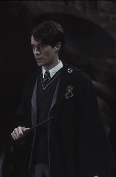 a man in a harry potter costume holding a wand