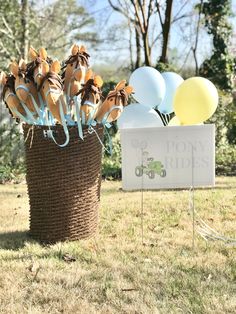 a basket filled with balloons next to a sign