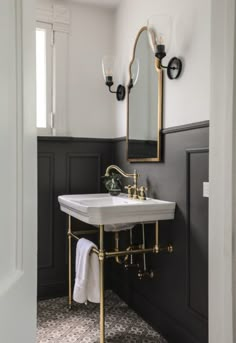 a white sink sitting under a mirror in a bathroom