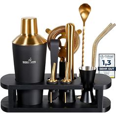 an assortment of gold and black kitchen utensils on a tray with the price label below it