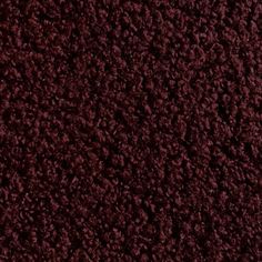 the texture of an old carpet with dark red colors