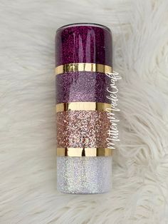 the purple and gold glitter tumbler is sitting on a white furnishing with it's lid open