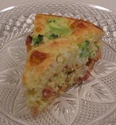 a piece of broccoli and cheese quiche on a glass plate