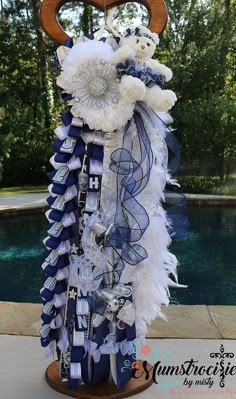 a blue and white decoration with two teddy bears on top of it next to a pool