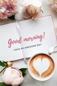 a cup of coffee next to a book with the words good morning have an awesome day