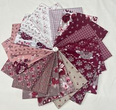 a bunch of different types of cloths on a white surface with the colors red, pink, and grey