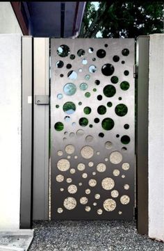 an open metal door with circles on it