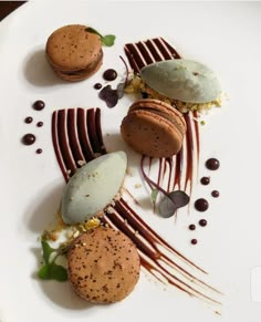 a white plate topped with three desserts covered in chocolate