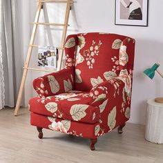 a living room with a red floral chair and ladder leaning against the wall next to it