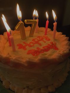 a birthday cake with lit candles on it