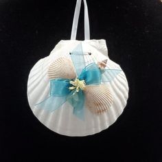 a seashell ornament with a blue bow on it