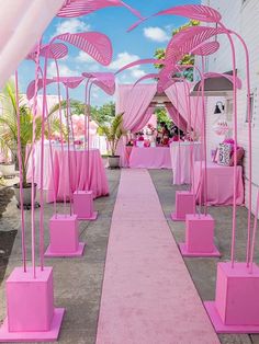 a long pink walkway lined with chairs and umbrellas