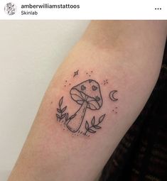 a small mushroom tattoo on the arm