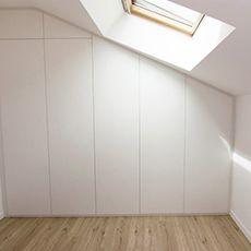 an empty room with white walls and wooden floors