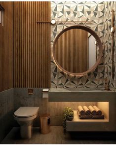 a bathroom with a circular mirror above the sink and wooden paneling on the wall