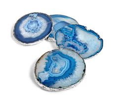 three pieces of blue and white agate glass with silver rims on a white background