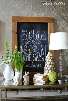 an image of a table with flowers on it and a chalkboard in the background