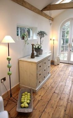 a living room with wooden floors and white walls