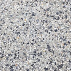 a close up view of the surface of a concrete floor with small rocks and gravel