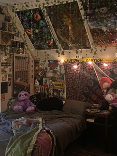 a bed room with a neatly made bed and lots of decorations on the ceiling above it