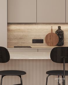 two black chairs sitting in front of a counter with a cutting board on top of it