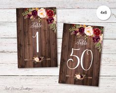 two wooden table numbers with flowers on them