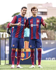 two men standing next to each other on a soccer field