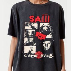 a person wearing a black shirt with pictures of people on it and the words sau game over