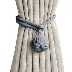 a curtain with a knot tied to it's side and the end of its cord