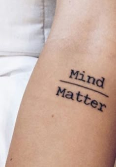 a person with a tattoo on their arm that says mind matter