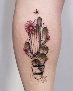 a woman's thigh with a cactus and flower tattoo on it