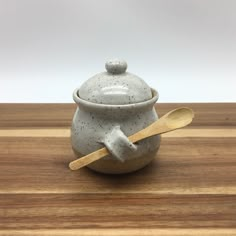 a ceramic bowl with a wooden spoon in it