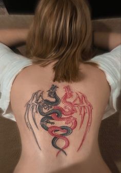 a woman with a dragon tattoo on her back