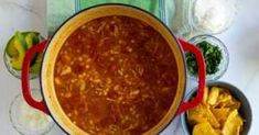 a large pot filled with chili and tortilla chips on top of a table