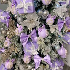 a christmas tree with purple and silver decorations