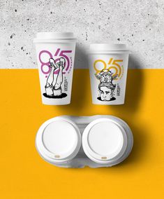 two cups with lids are next to each other