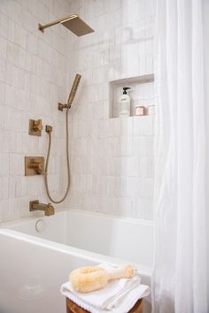 a bathroom with a tub and shower head