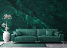 a living room with green marble wallpaper and a large couch in front of it