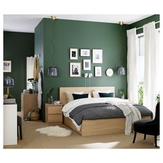 a bedroom with green walls and pictures on the wall