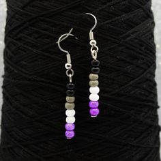 Show your ace pride with these asexual flag earrings! These minimalist beaded pendants have glass beads in black, gray, white, and purple, the colors of the asexual and demisexual flags. Shipped earrings are stainless steel, shipped sterile, and come with rubber backs. Hand assembled. Need more earrings? Check them out here: https://www.etsy.com/shop/QuietMischief?section_id=31782094 More ace pride here: https://www.etsy.com/shop/QuietMischief?search_query=asexual Pride Jewelry Diy, Ace Flag, Pride Jewelry, Pride Jewellery, Multiple Earrings, Pride Bracelet, Wire Wrapped Jewelry Tutorials, Asexual Pride, Themed Jewelry