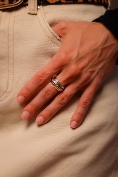 a woman's hand with two rings on her hip