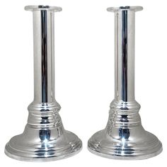 pair of silver candlesticks on white background