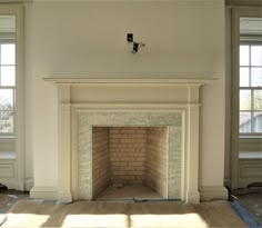 an empty room with a fire place in the middle