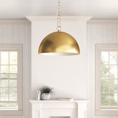 a living room with white walls and a gold light fixture hanging from the ceiling over a fireplace