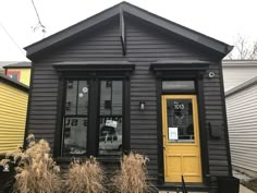 a black house with yellow door and windows