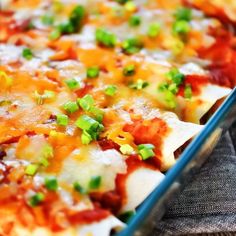 a cheesy pizza with green onions and cheese