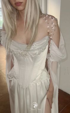 a woman with blonde hair wearing a white dress