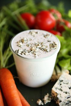 carrots, celery, and cheese are on the table next to some vegetables