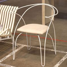 a white chair sitting on top of a tiled floor