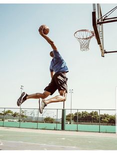 a man jumping in the air to dunk a basketball